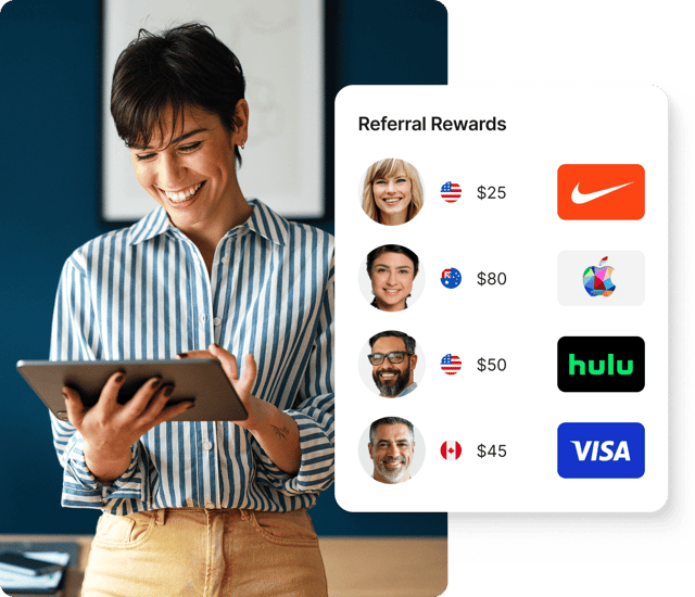 Smiling woman using Giftogram's "Referral Rewards" interface on a tablet to incentivize referrals.