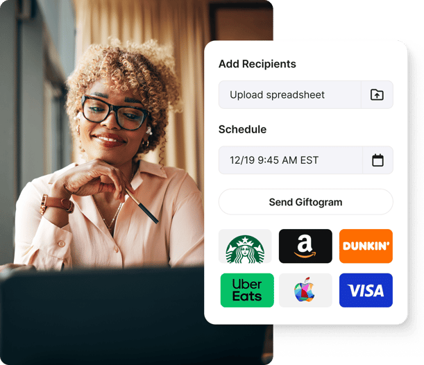Smiling woman using Giftogram to upload recipients, schedule delivery, and send gift cards for employee appreciation.