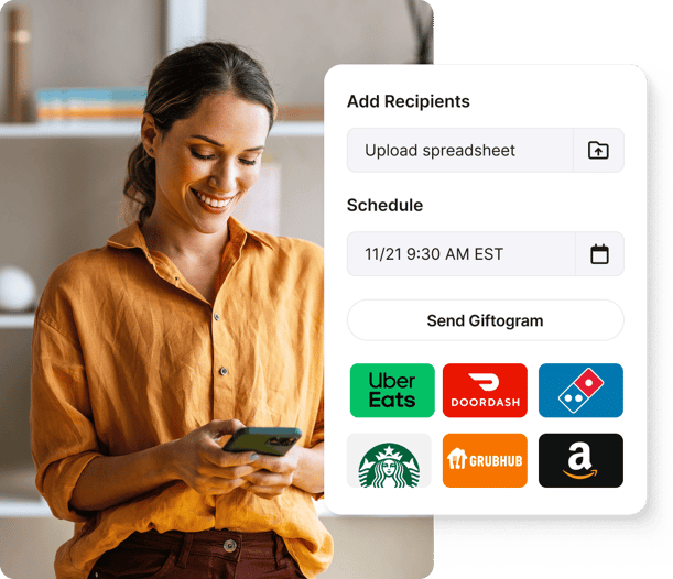 Smiling woman using Giftogram to schedule sending gift cards from brands like Uber Eats and Amazon, recognizing recipients.