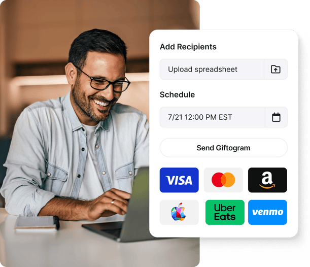 Smiling man efficiently scheduling and sending Giftogram gift cards to recognize recipients. Shows bulk upload and diverse brands.