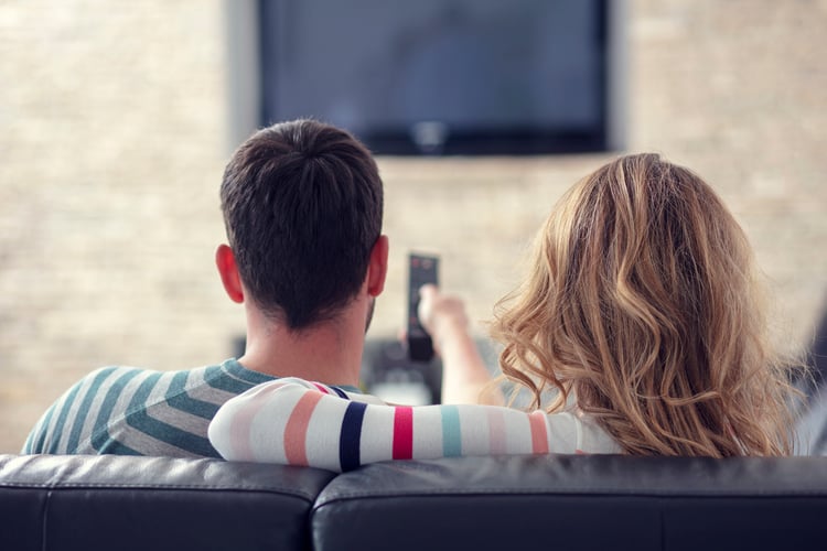 A newlywed couple watching TV 