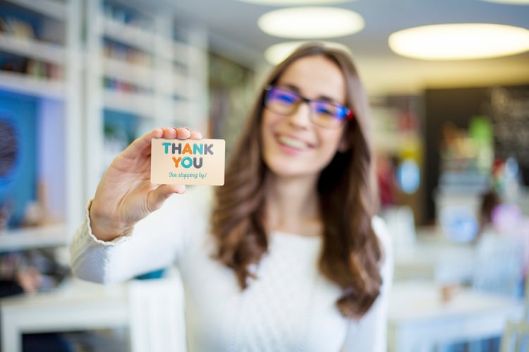 Woman showing off her gift card