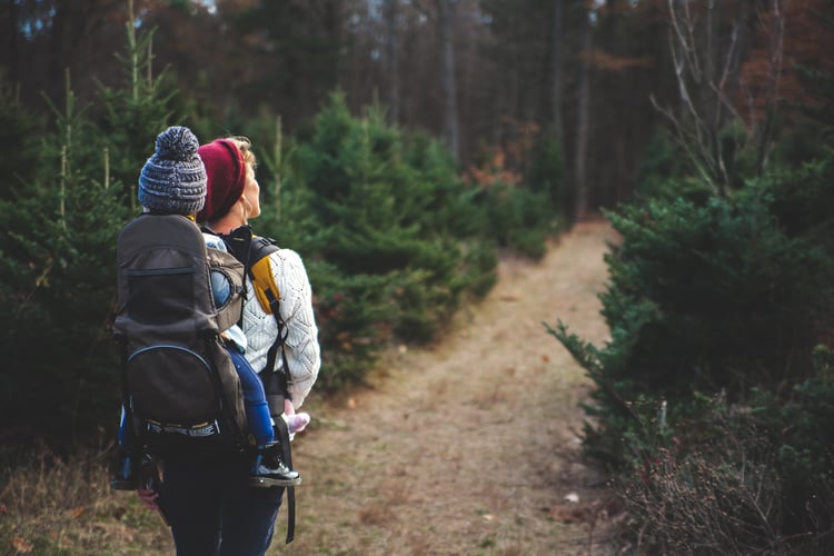 Woman hiking with child on her back