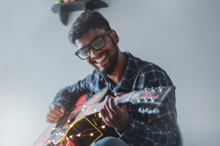 Employee playing guitar to make work environment more fun 