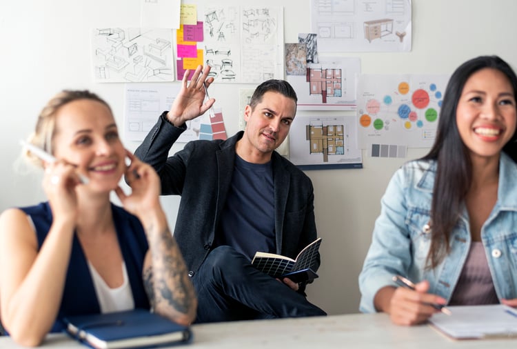 A designer raises his hand at an employee focus group
