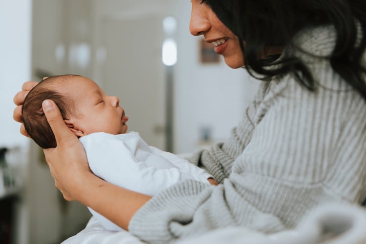 A working parent on maternity leave with her new baby