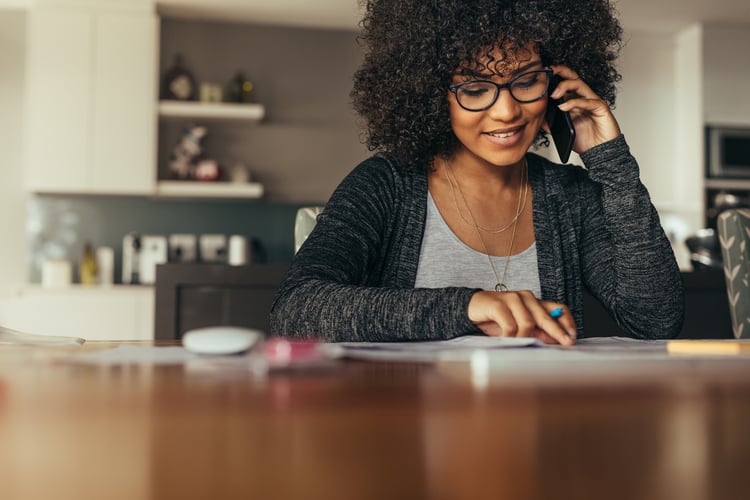 A woman on a customer service call receiving a gift card 