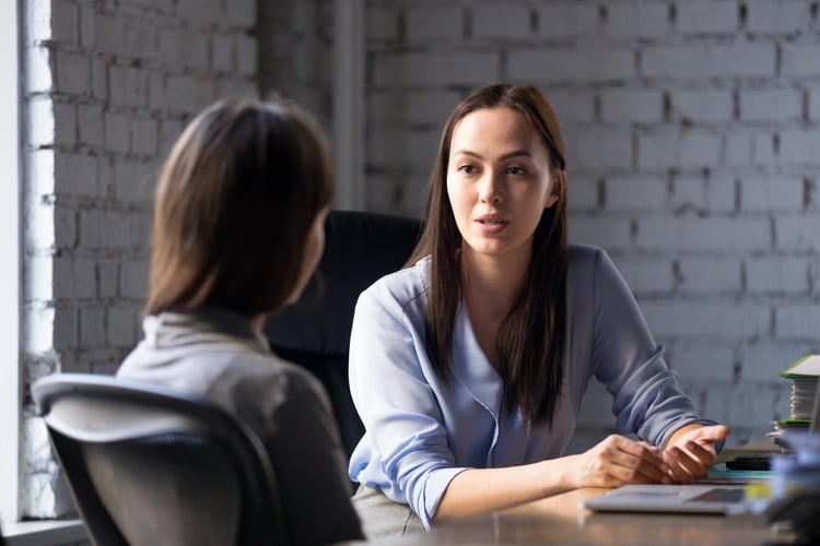 A manager holding a check-in meeting with a call center employee