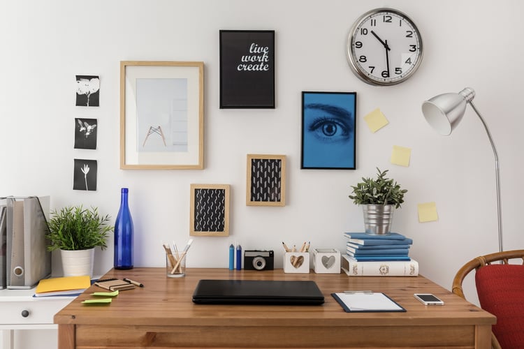 a desk decorated with work from local artists