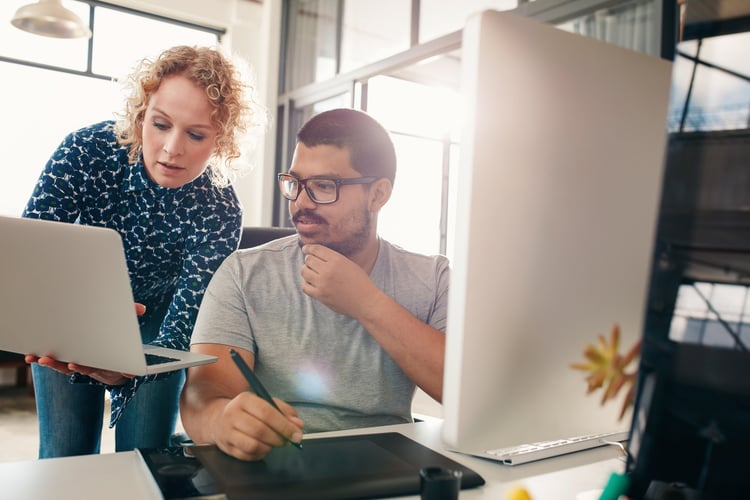 A manger and employee reviewing career path milestones