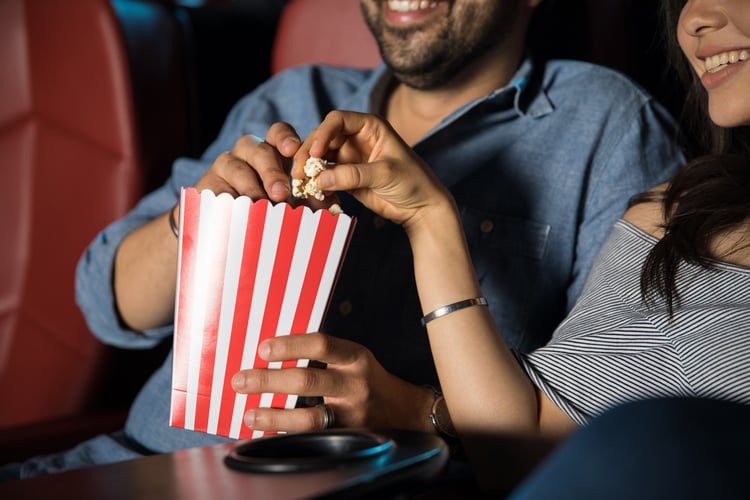 A couple at the movies with their AMC gift card