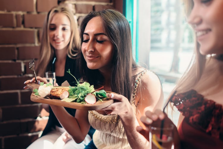 An employee dining at a new restaurant with a gift card