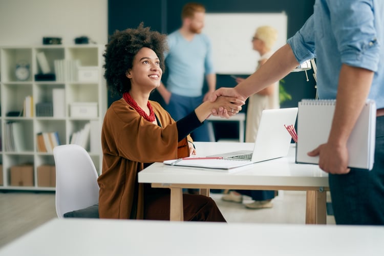 Two employees shaking hands