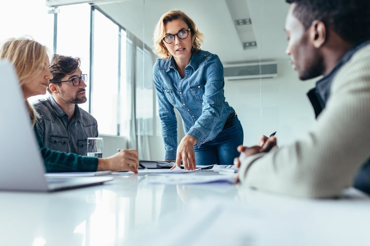 A female employee meeting with a small group of colleagues