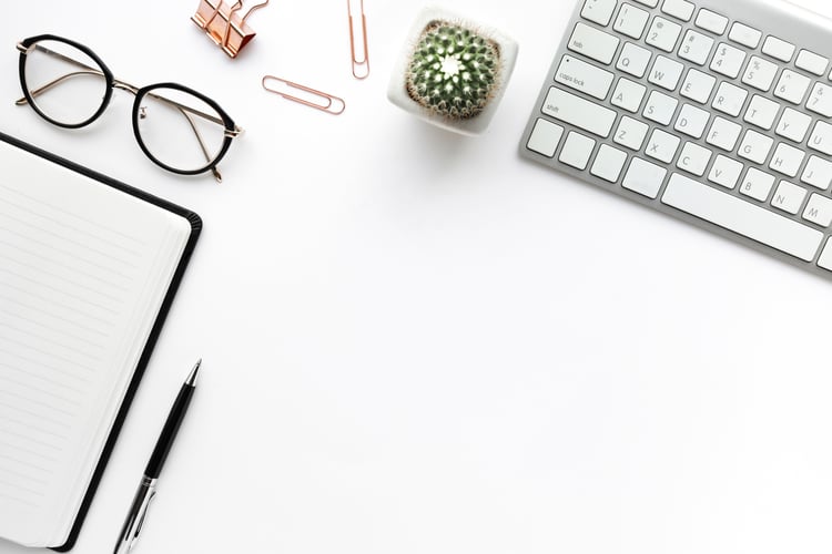 A desk with writing supplies and decor