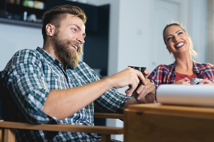 Employees laughing together having coffee