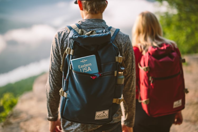 Male and female millennial enjoying work-life balance by traveling