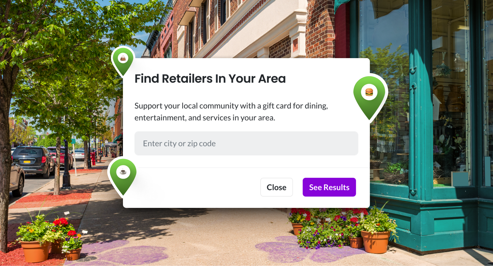 Street with storefronts and trees, featuring a "Find Retailers In Your Area" pop-up for local gift card options, with location pins.