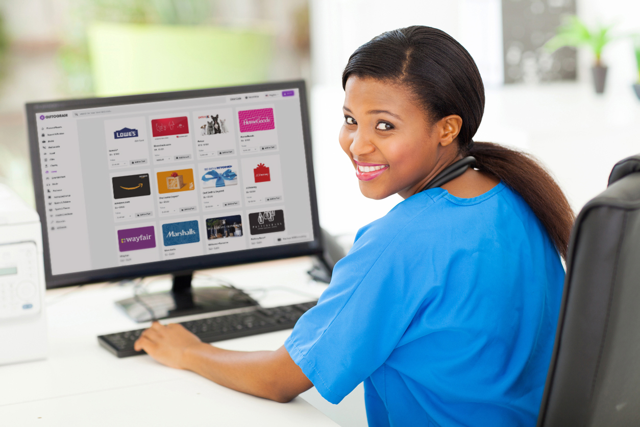 Medical professional smiles while using Giftogram to choose gift cards for staff recognition.