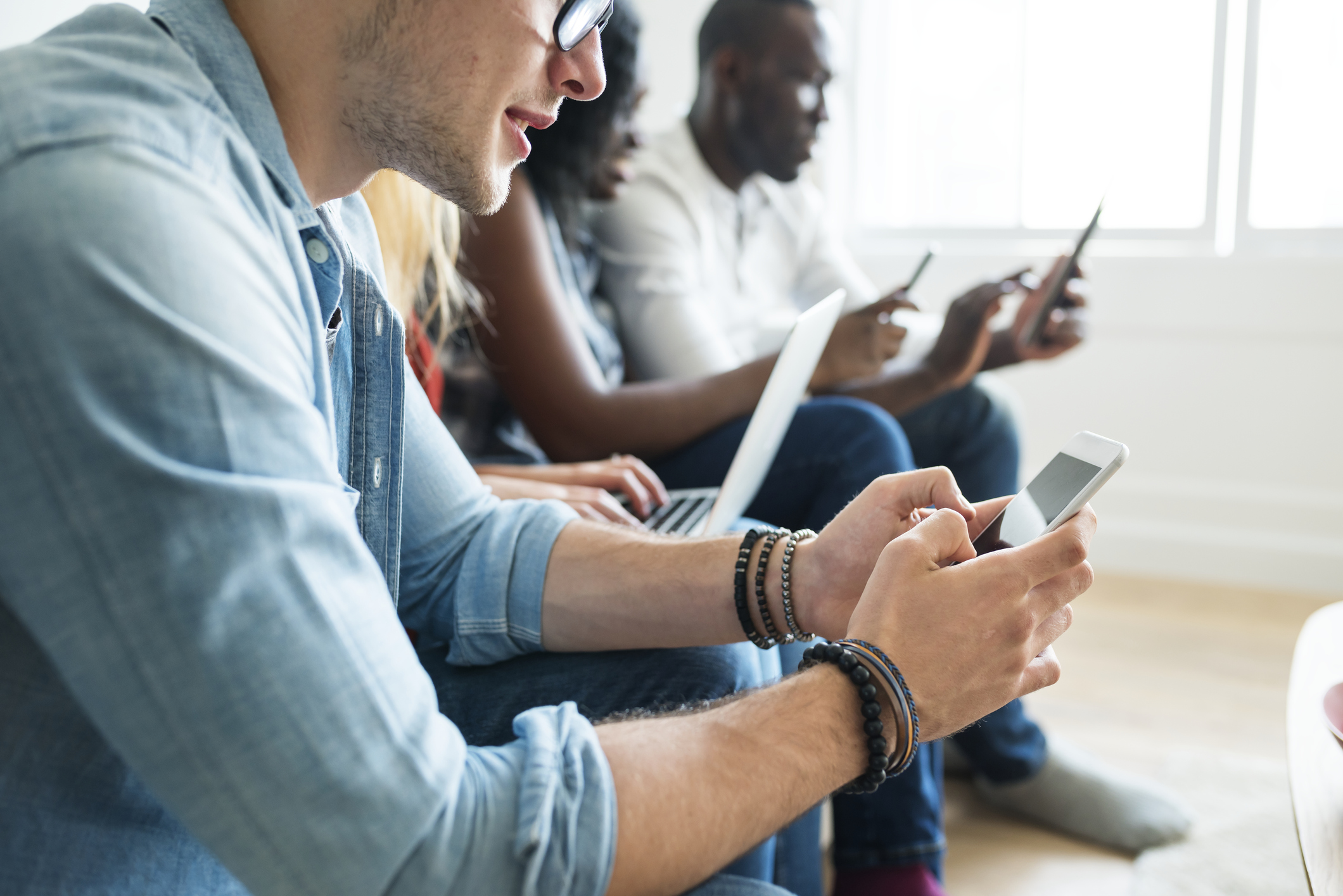 Employees redeeming Giftogram virtual gift cards on various different electronic devices