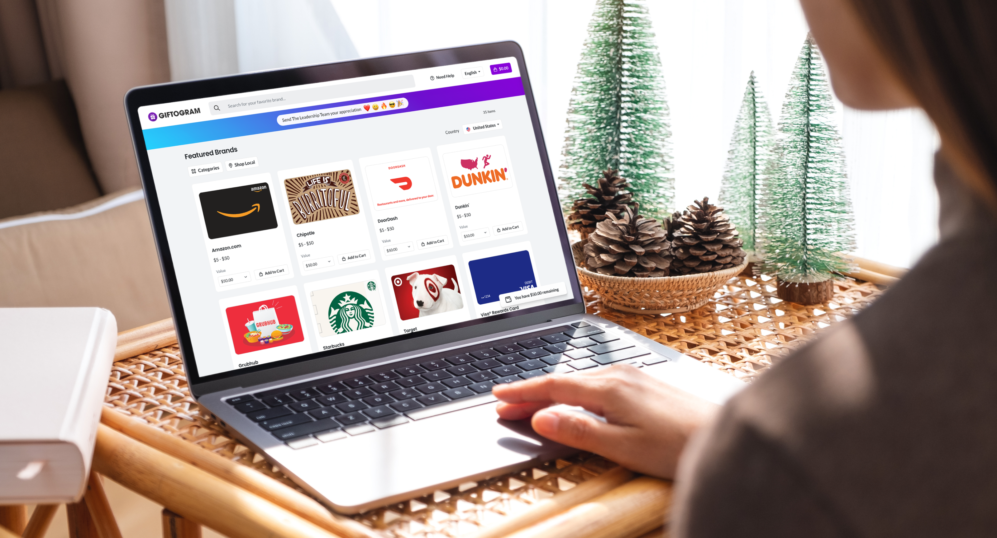 Person viewing Giftogram's 'Featured Brands' on a laptop, showing appreciation for their leadership team.